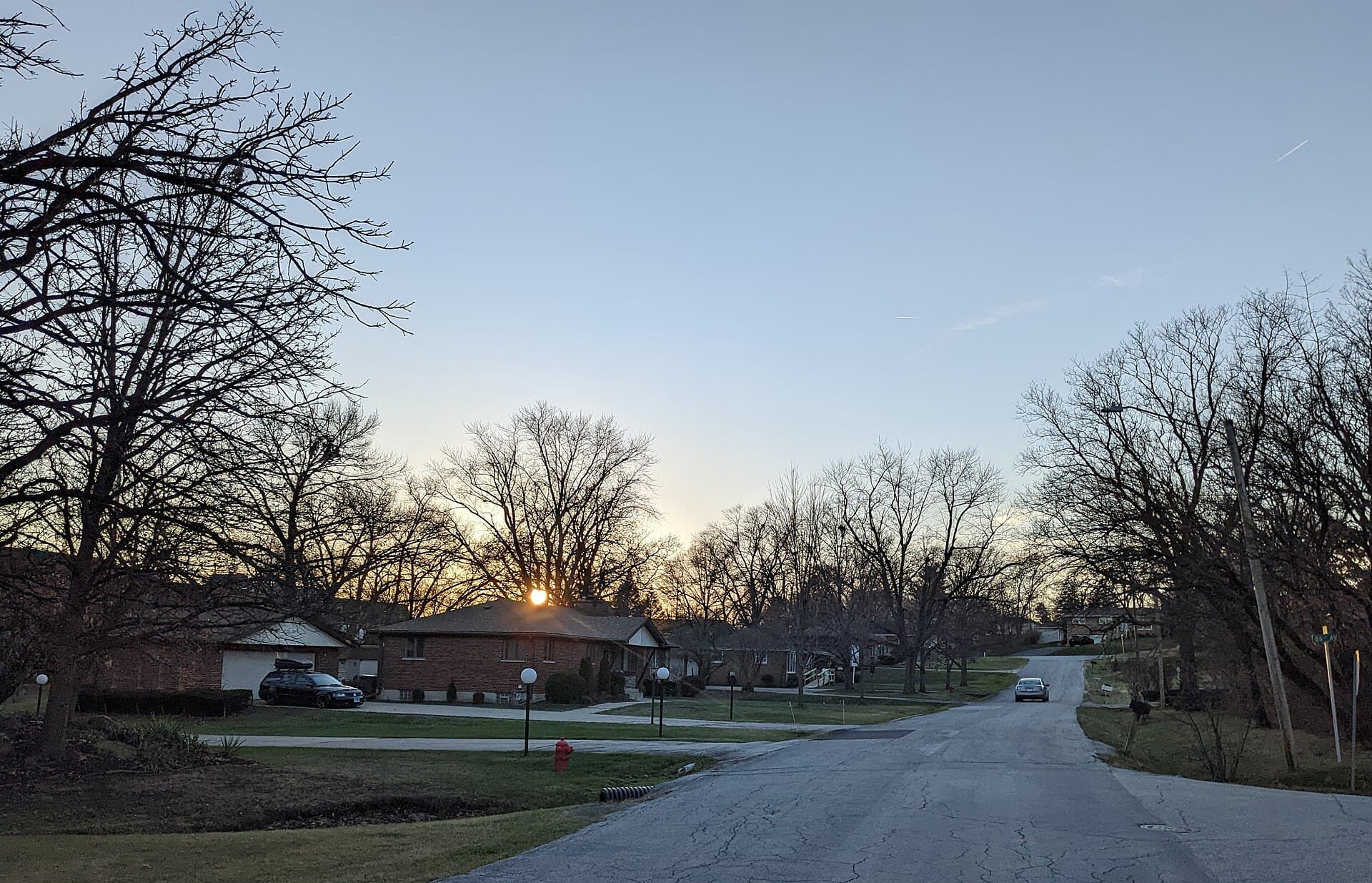 A Hickory Hills residential street at sunset in December